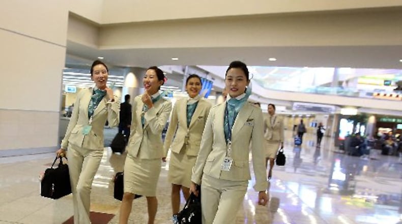 Flight attendants for Korean Air walk on Concourse F in the Internal Terminal at Hartsfield-Jackson International Airport.