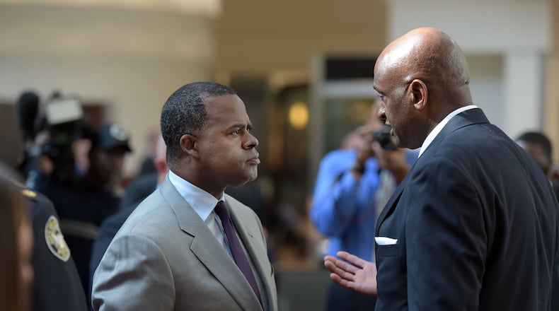 Federal prosecutors have sought testimony and records related to a secret settlement between then-Mayor Kasim Reed, left, and Miguel Southwell, the former airport general manager who Reed fired in 2016. The two men are pictured here in a photograph from 2015. KENT D. JOHNSON / AJC