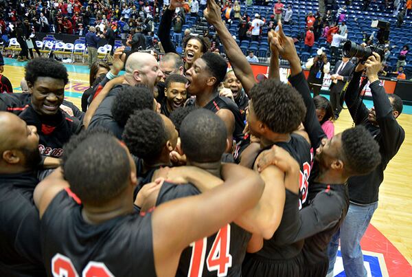 MARCH 6, 2014 MACON Jonesboro Cardinals head coach Dan Maehlman (center left) celebrates with his players after the game. Coverage of the Class AAAA boys basketball championship between Columbia Eagles and Jonesboro Cardinals. Jonesboro beat Columbia, 56-51. KENT D. JOHNSON / KDJOHNSON@AJC.COM Jonesboro Cardinals head coach Dan Maehlman (center, left) celebrates with his players after their 56-51 win over the Columbia Eagles in the Class AAAA boys basketball championship Thursday, March 6, 2014, in Macon. (Kent D. Johnson / AJC)