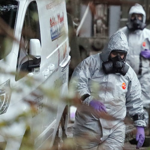FILE - Personnel in protective gear work on a van in Winterslow, England, March 12, 2018, as investigations continue into the nerve-agent poisoning of former Russian intelligence officer Sergei Skripal and his daughter Yulia. (AP Photo/Frank Augstein, File)