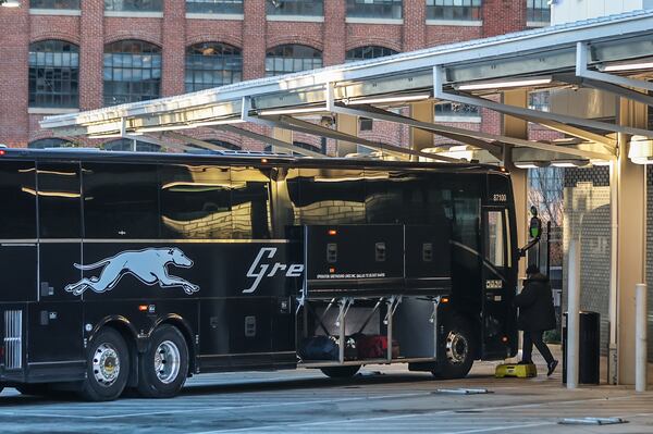 Passengers board a Greyhound bus outside the Forsyth Street station in downtown Atlanta on Friday morning.