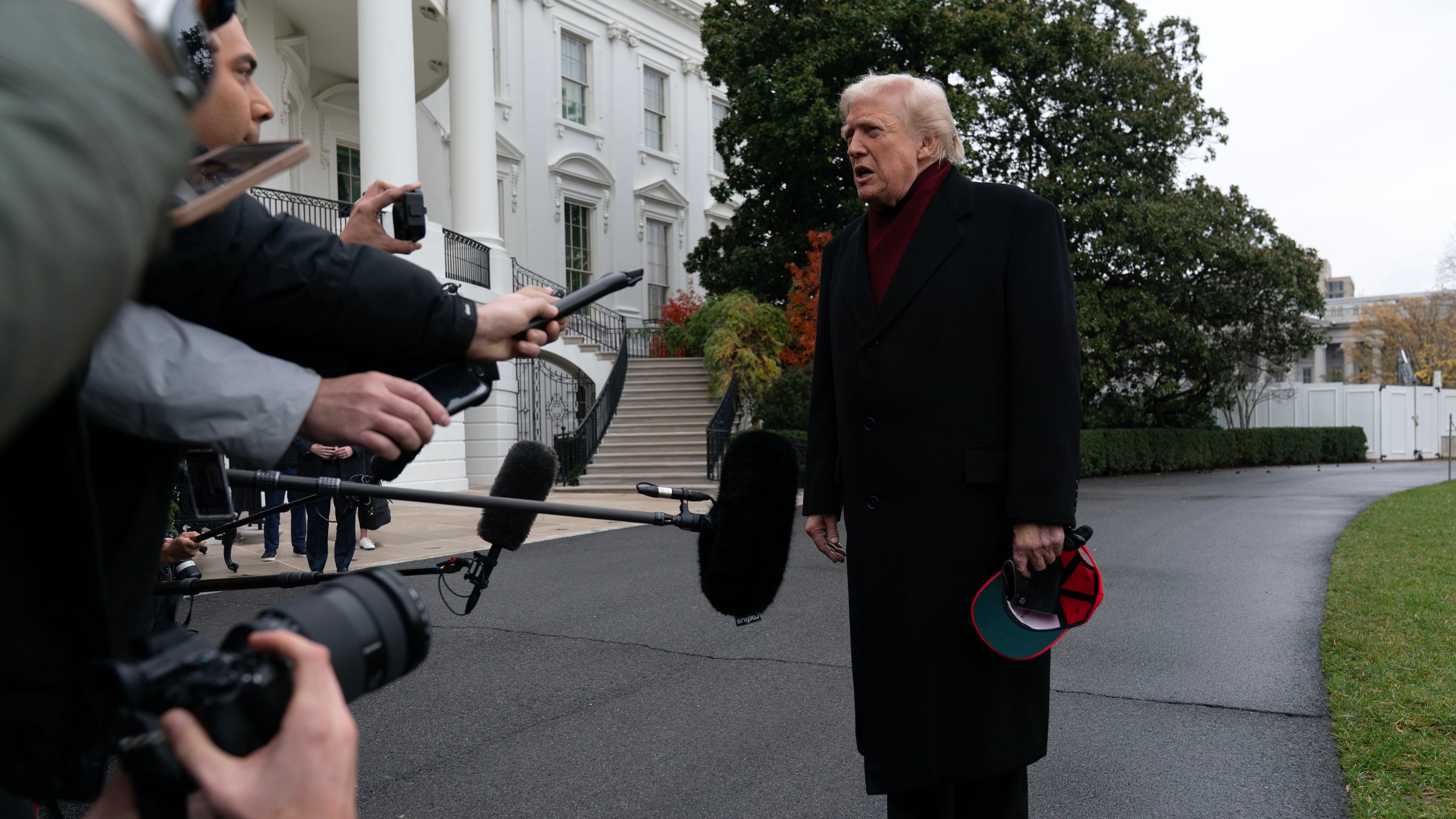 President Donald Trump talks to reporters as he departs from the South Lawn of the White House, Saturday, Nov. 22, 2025, in Washington, en route to Joint Base Andrews. (AP Photo/Jose Luis Magana)