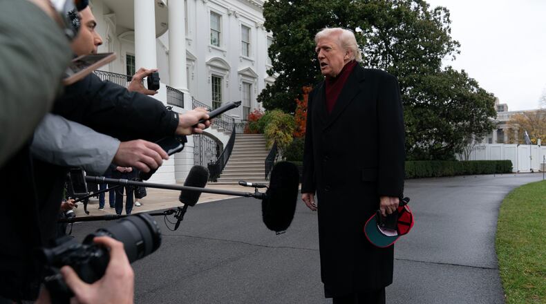 President Donald Trump talks to reporters as he departs from the South Lawn of the White House, Saturday, Nov. 22, 2025, in Washington, en route to Joint Base Andrews. (AP Photo/Jose Luis Magana)