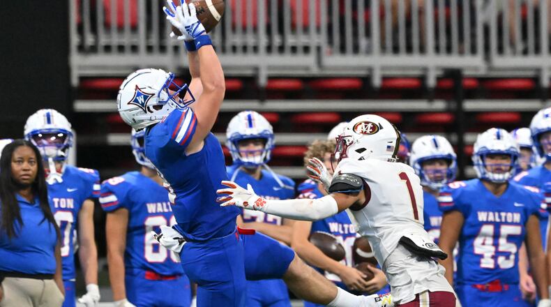 August 20 , 2022 Atlanta - Walton's Hunter Teal (9) makes a touchdown pass over Mill Creek's Jamal Anderson (1) during the 2022 Corky Kell Classic at Mercedes Benz Stadium on Saturday, August 20, 2022. Mill Creek won 44-41 over Walton. (Hyosub Shin / Hyosub.Shin@ajc.com)