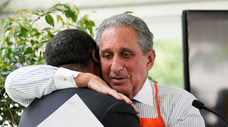 April 21,  2017 - Atlanta - Arthur Blank hugs Mayor Kasim Reed after Reed gave a warm introduction when the team unveiled plans for the "Home Depot Backyard."