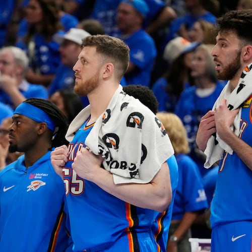Oklahoma City Thunder guard Luguentz Dort, left, and Thunder centers Isaiah Hartenstein, center, and Chet Holmgren watch the action on the court from the team bench during the second half of Game 7 of the Western Conference finals of the NBA basketball playoffs series against the San Antonio Spurs, Saturday, May 30, 2026, in Oklahoma City. (AP Photo/Tony Gutierrez)