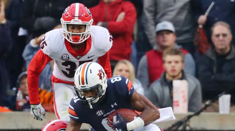 Auburn wide receiver Darius Slayton makes a touchdown catch in front of Georgia defenders Malkom Parrish and Aaron Davis to take a 16-7 lead during the second quarter on Saturday, Nov. 11, 2017. (Curtis Compton/Atlanta Journal-Constitution/TNS)