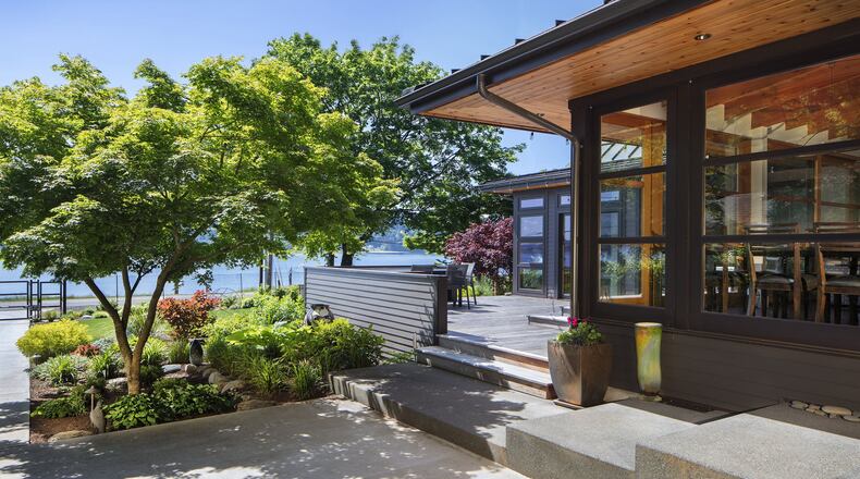 Bob and Mary Carlson s Bainbridge Island home originally was a 1930s-era cabin. Architect Tom Kundig remodeled it in the early 1980s, and now architect Tom Kuniholm has done a major remodel that expands and updates many of those aesthetic cues, he says. Bob Grimm was the builder for the remodel (Bob Carlson did a lot of hands-on work himself, and Mary Carlson handled interior design). (Steve Ringman/The Seattle Times/TNS)