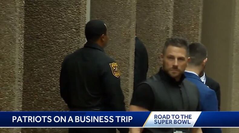 DeKalb police Captain Curtis Williams (left) was spotted on TV reports of the New England Patriots arriving in Atlanta in January.