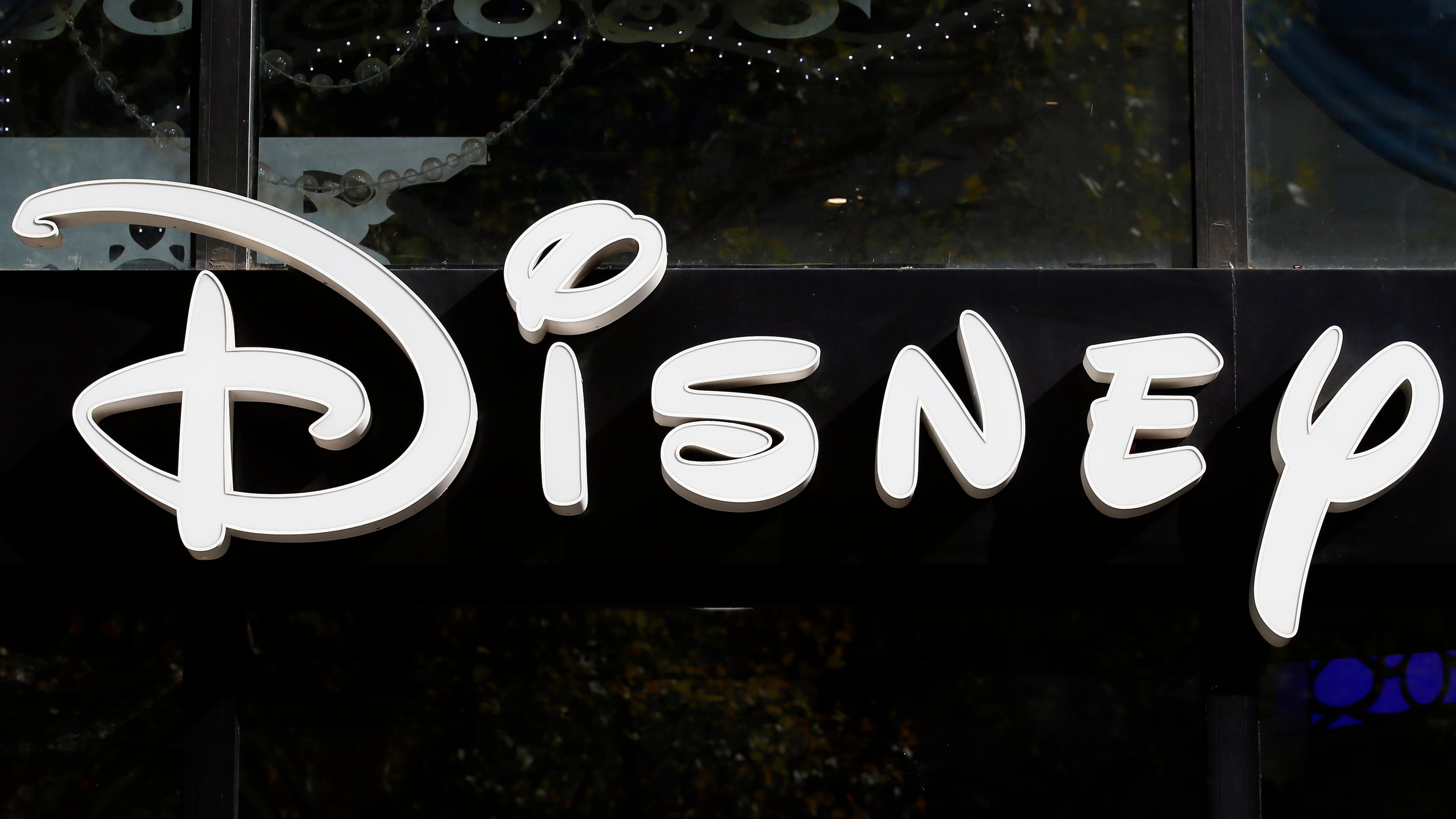 FILE - The Disney logo is seen on their store along the Champs Elysees Avenue in Paris on Sept. 20, 2017. (AP Photo/Francois Mori, File)