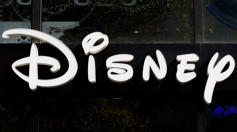 FILE - The Disney logo is seen on their store along the Champs Elysees Avenue in Paris on Sept. 20, 2017. (AP Photo/Francois Mori, File)