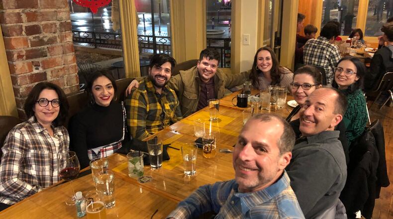 Andy Gutman (lower right) and family celebrate an engagement at a restaurant in Arvada, Colorado, a suburb of Denver. His son and his son's fiancee are seated at the back corner of the table.