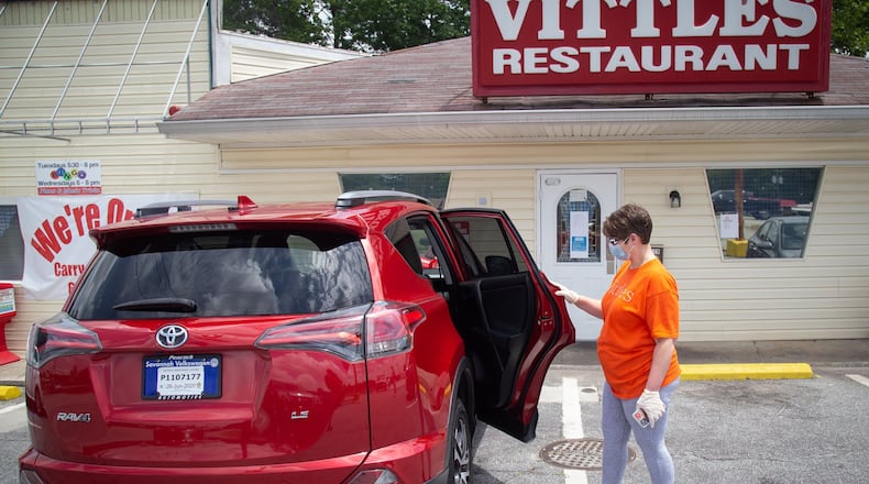 Vittles Restaurant owner Charity Salyers looks over her new 2017 Toyota Rav 4 outside her Smyrna restaurant Thursday, May 14, 2020. STEVE SCHAEFER FOR THE ATLANTA JOURNAL-CONSTITUTION