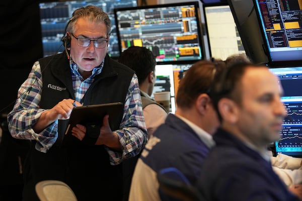 Traders work on the floor at the New York Stock Exchange in New York, Thursday, April 3, 2025. (AP Photo/Seth Wenig)