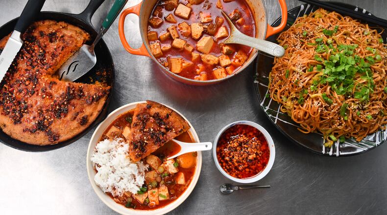 These dishes featuring chili crisp are adapted from recipes by cookbook authors James Park and Jing Gao. From left: Cheesy Cornbread with Green Chiles, Silken Tofu Soup (in pot and in white bowl), Very Nutty Chili Crisp (bottom right) and Chilled Sesame Noodles.  
(Styling by Wendell Brock. Chris Hunt for The Atlanta Journal-Constitution)