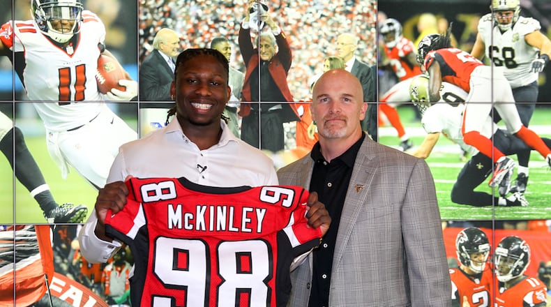Takkarist McKinley shares the stage with his new head coach, the Falcons Dan Quinn. (Photo courtesy of AtlantaFalcons.com)