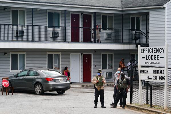 Armed guards are seen on the premises of the Efficiency Lodge on Flat Shoals Road on Wednesday, October 7, 2020, in Panthersville. (Elijah Nouvelage for The Atlanta Journal-Constitution)