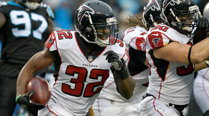 CHARLOTTE, NORTH CAROLINA - DECEMBER 23: Brian Hill #32 of the Atlanta Falcons runs the ball against the Carolina Panthers in the fourth quarter during their game at Bank of America Stadium on December 23, 2018 in Charlotte, North Carolina. (Photo by Grant Halverson/Getty Images)