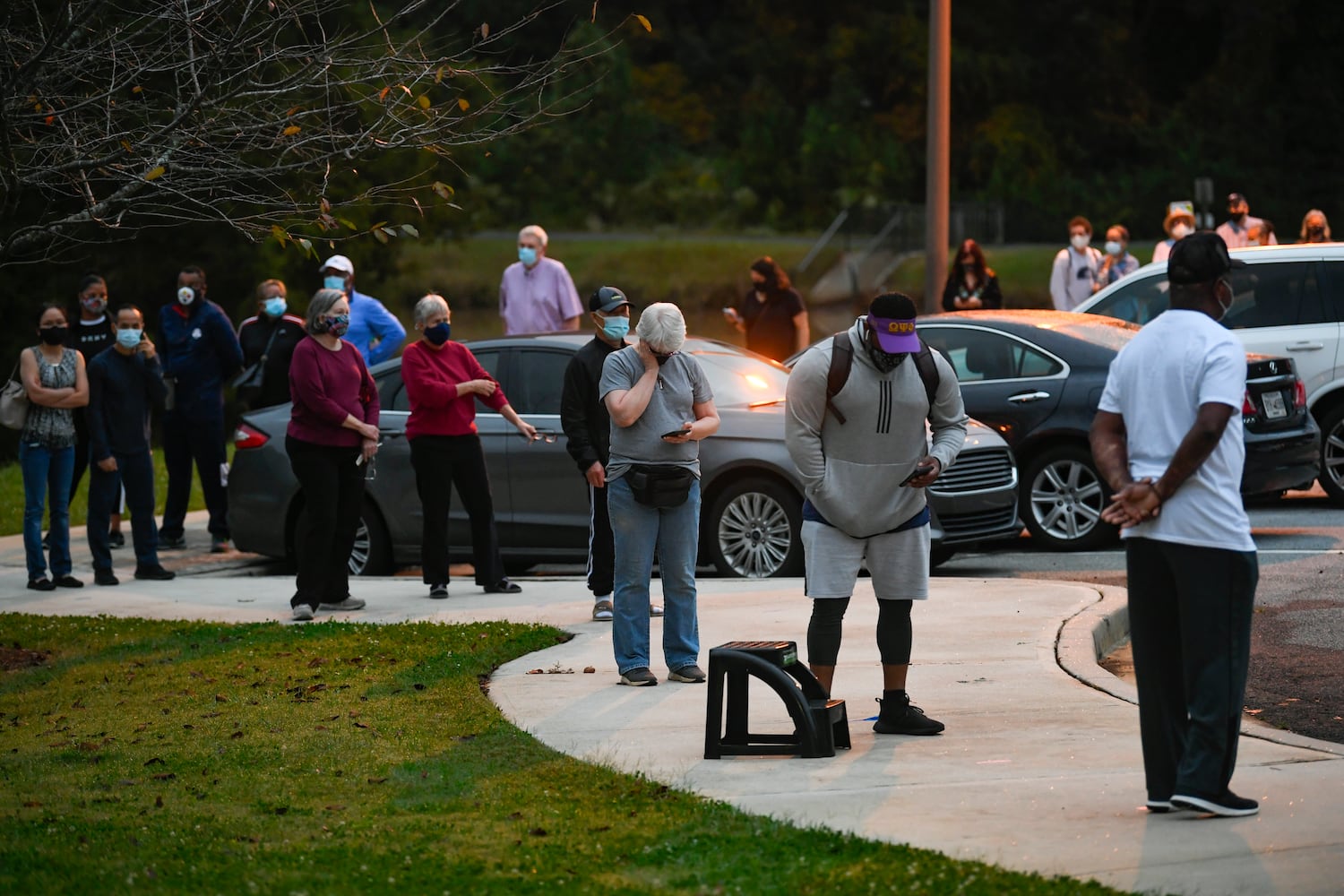 A line snakes around the parking lot as the first day of early voting gets underway on Monday, Oct. 12, 2020, at the Mountain Park Activity Building in Stone Mountain. JOHN AMIS FOR THE ATLANTA JOURNAL- CONSTITUTION