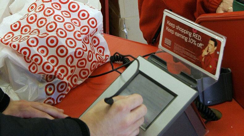 FILE - In this Jan. 18, 2008 file photo, a customer signs his credit card receipt at a Target store in Tallahassee, Fla. The U.S. is the juiciest target for hackers hunting credit card information. And experts say incidents like the recent data theft at Target’s stores will get worse before they get better. That’s in part because U.S. credit and debit cards rely on an easy-to-copy magnetic strip on the back of the card, which stores account information using the same technology as cassette tapes. The breach that exposed the credit card and debit card information of as many as 40 million Target customers who swiped their cards between Nov. 27 and Dec. 15 is still under investigation. (AP Photo/Phil Coale, File)