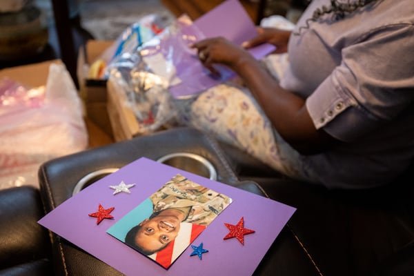 Oneida Oliver-Sanders, mother of Army Reserve Sgt. Kennedy L. Sanders, makes Memorial Day craft packages for elementary school students at her home in Waycross on May 16, 2025. (Arvin Temkar/AJC)