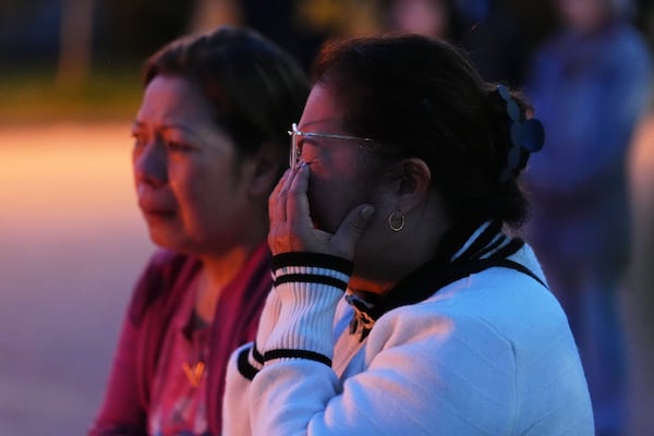 Liza Ahyeng wipes away tears at a memorial for victims after a vehicle drove into a crowd during a Filipino heritage festival in Vancouver, British Columbia, Sunday, April 27, 2025. (AP Photo/Lindsey Wasson)