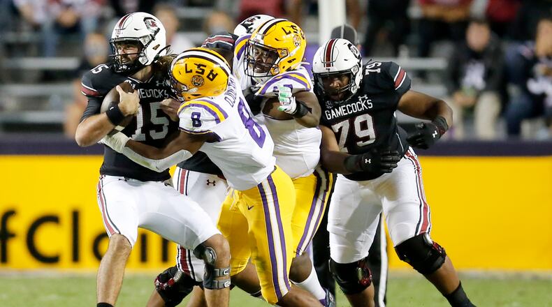 South Carolina quarterback Collin Hill (15) is brought down by LSU linebacker BJ Ojulari (8) during the first half of an NCAA college football game in Baton Rouge, La., Saturday, Oct. 24, 2020. (AP Photo/Brett Duke)