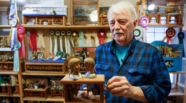 Carwood “Woody” Jones holds one of his wood sculpture prototypes at his home showroom in Decatur. Over 40 years, Jones has produced more than 3,000 pieces of mechanical amusements. (Miguel Martinez /miguel.martinezjimenez@ajc.com)