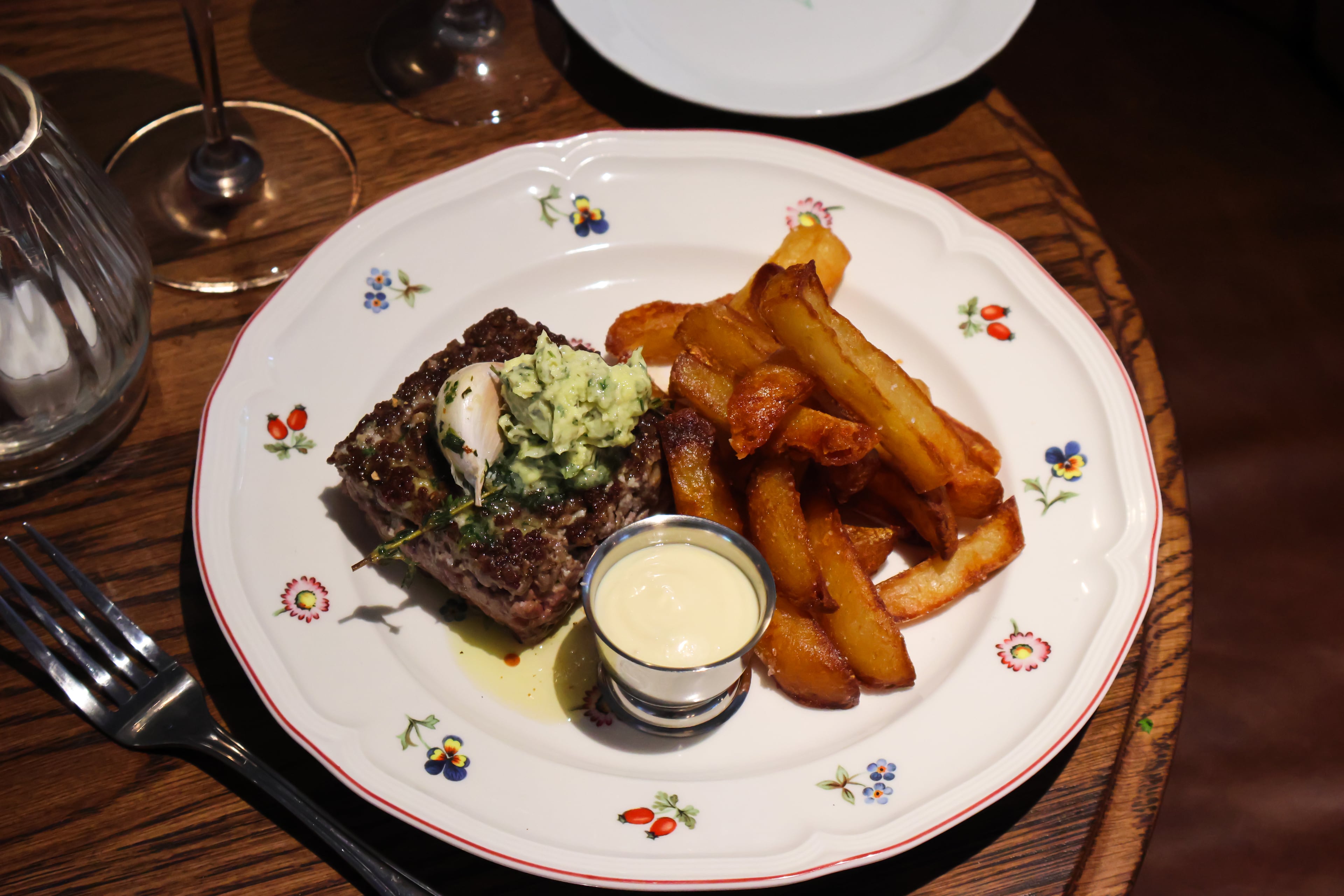 La Vie en Rose is an entree highlight at Little Sparrow, with steak haché — ground rib-eye shaped into a square patty and cooked like a steak —served with pomme frites and aioli. (Courtesy of Little Sparrow)