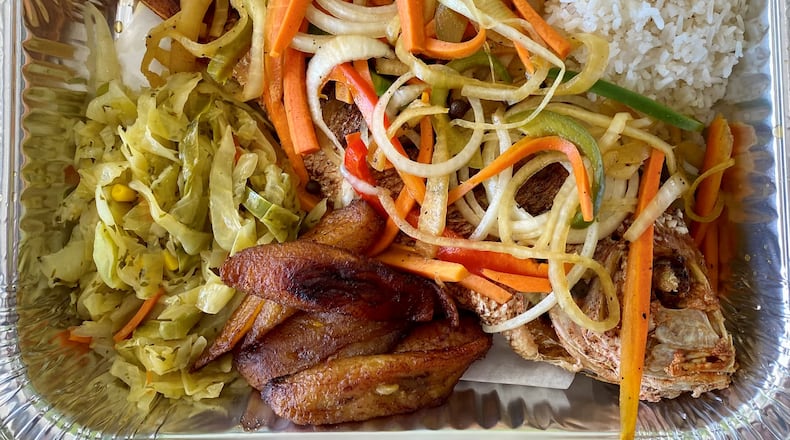 Kingston’s Caribbean’s escovitch consists of a fried, whole red snapper topped with spicy pickled vegetables, plus sides of rice, sweet plantains and cabbage. Wendell Brock for The Atlanta Journal-Constitution