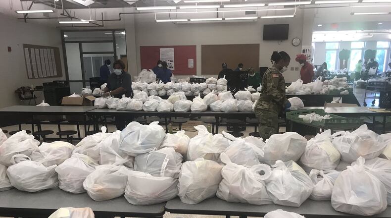 Atlanta Public Schools, with assistance from the Georgia National Guard, prepares to distribute meals to students and families on Monday, April 13, 2020. On the day after spring break, the district switched from a daily food distribution schedule to a weekly schedule to assist those affected by the coronavirus shutdown. SUBMITTED PHOTO FROM ATLANTA PUBLIC SCHOOLS SUPERINTENDENT MERIA CARSTARPHEN