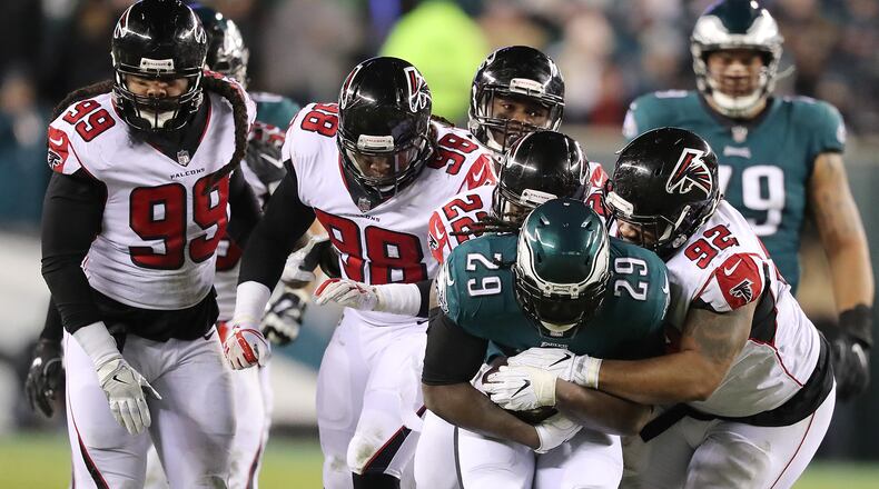 January 13, 2018 Philadelphia: Eagles running back LeGarrette Blount picks up yardage past Falcons defenders with Dontari Poe making the tackle during the first half in their NFC Divisional Game on Saturday, January 13, 2018, in Philadelphia.    Curtis Compton/ccompton@ajc.com