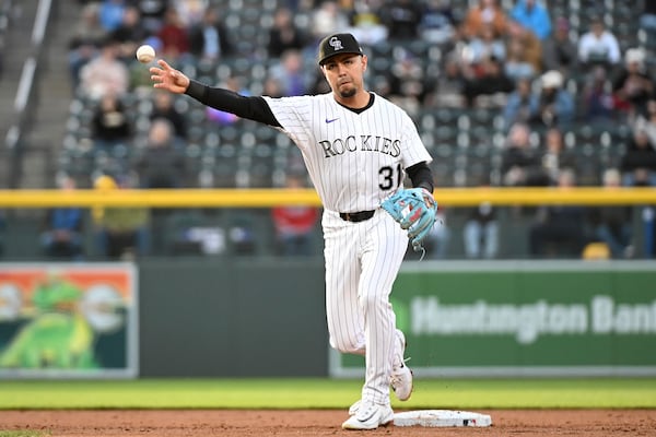 Colorado Rockies shortstop Alan Trejo (31) throws to first base for the first out of the third inning of a baseball game against the Atlanta Braves Tuesday, April 29, 2025, in Denver. (AP Photo/Geneva Heffernan)