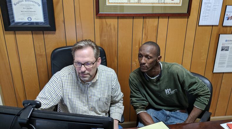 Kirk Lyman-Barner, an insurance agent in Middle Georgia, shows Tyrone Jenkins, a forklift driver who lives in Lee County, options for his health insurance policy under the Affordable Care Act for 2018. (PHOTO contributed to the AJC by Cori Lyman Barner)