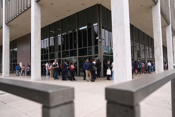 People line up outside the Los Angeles Federal Building in Los Angeles, housing the U.S. Immigration and Customs Enforcement (ICE) and U.S. Citizenship and Immigration Services (USCIS) on Wednesday, June 25, 2025. (AP Photo/Damian Dovarganes)