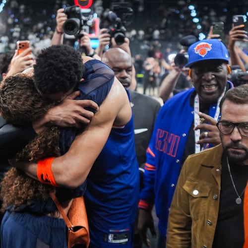 New York Knicks center Karl-Anthony Towns is embraces as he leaves the court after Game 2 of the NBA Finals basketball series against the San Antonio Spurs, Friday, June 5, 2026, in San Antonio. (AP Photo/Eric Gay)
