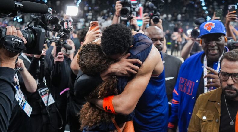 New York Knicks center Karl-Anthony Towns is embraces as he leaves the court after Game 2 of the NBA Finals basketball series against the San Antonio Spurs, Friday, June 5, 2026, in San Antonio. (AP Photo/Eric Gay)