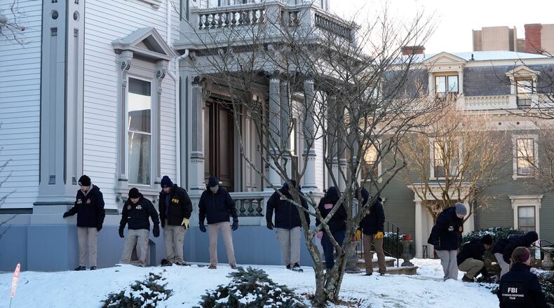Members of the FBI Evidence Response Team search for evidence near the campus of Brown University, Monday, Dec. 15, 2025, in Providence, R.I. (AP Photo/Robert F. Bukaty)