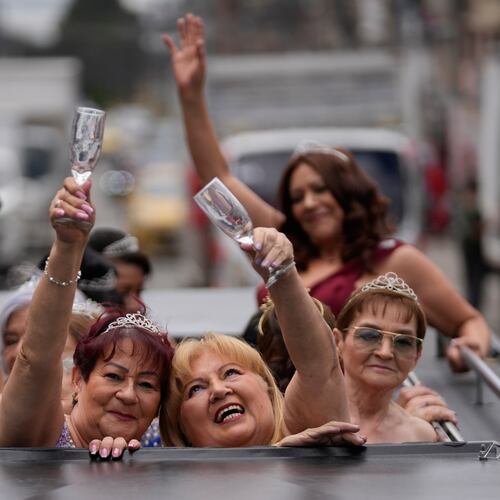 Blanca Guerrero, 67, left, and Gloria Sanabria, 67, right, ride in a limousine to a quinceanera celebration for women who never had a traditional 15th birthday party, organized by the Suenos Hechos foundation in Bogota, Colombia, Friday, Oct. 24, 2025.(AP Photo/Fernando Vergara)