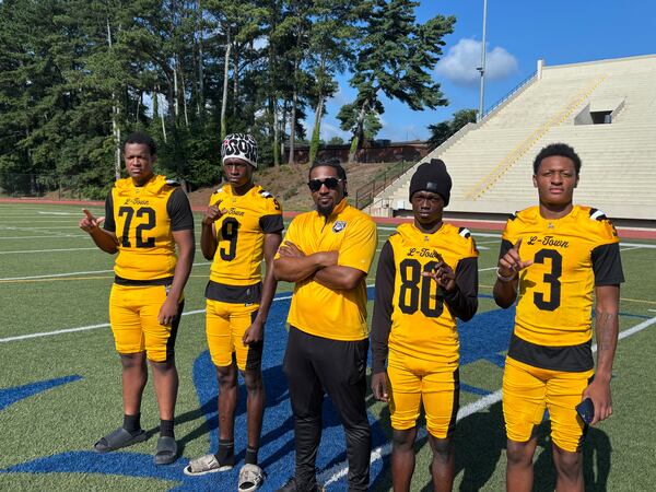 Defensive back Aketris Thomas (from left), cornerback TK Scarbourgh, coach Kevin Barnes and receivers Armani Myco and Anthony Flournoy, as well as the rest of the Lithonia football team, hope to build on last year’s 10-win season. (Stan Awtrey for the AJC)