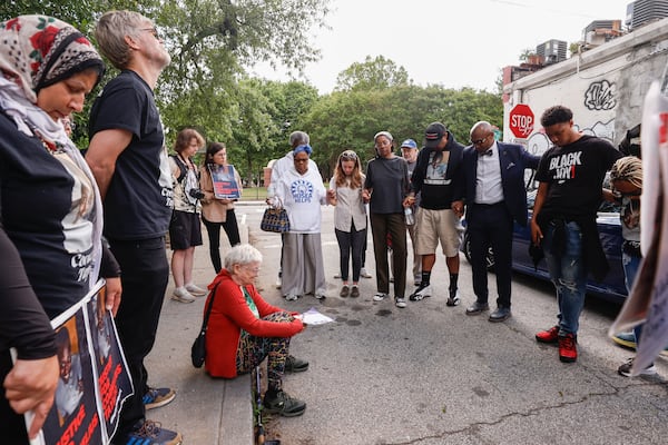 Homeless advocates pray following a press conference protesting city policies on clearing out those living in homeless encampments in Atlanta on Monday, May 5, 2025. (Natrice Miller/AJC)