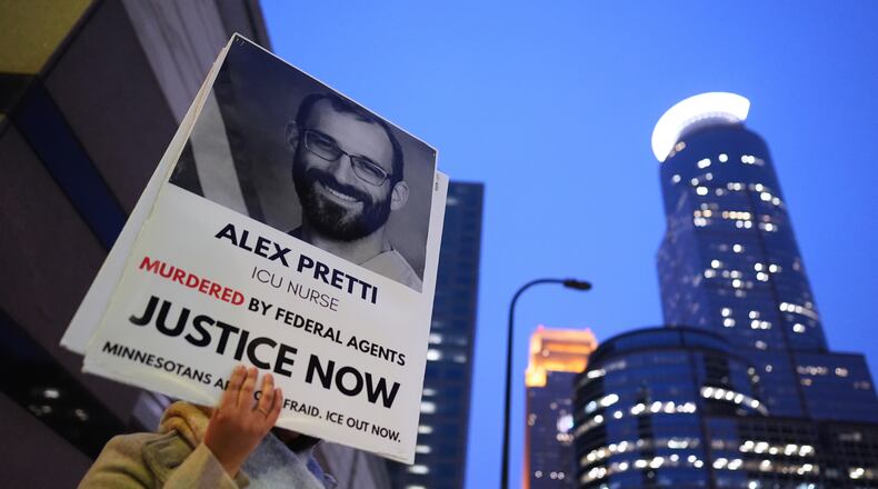 A person holds a sign of Alex Pretti during a protest outside the office of Sen. Amy Klobuchar, D-Minn., on Monday, Jan. 26, 2026, in Minneapolis. (AP Photo/Adam Gray)