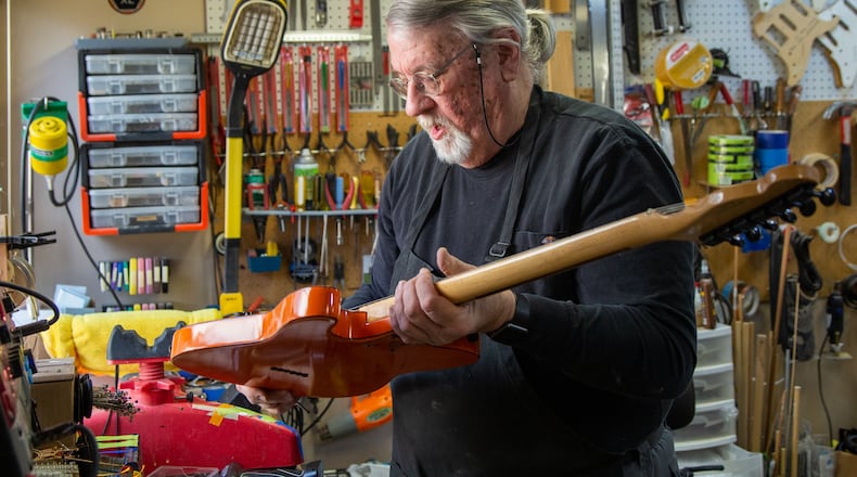 Bud Veazey works on a custom guitar in the basement workshop of his Lawrenceville home. He recently gave an electric guitar to a victim of the Nashville bombing who collection of guitars were destroyed. PHIL SKINNER FOR THE ATLANTA JOURNAL-CONSTITUTION.