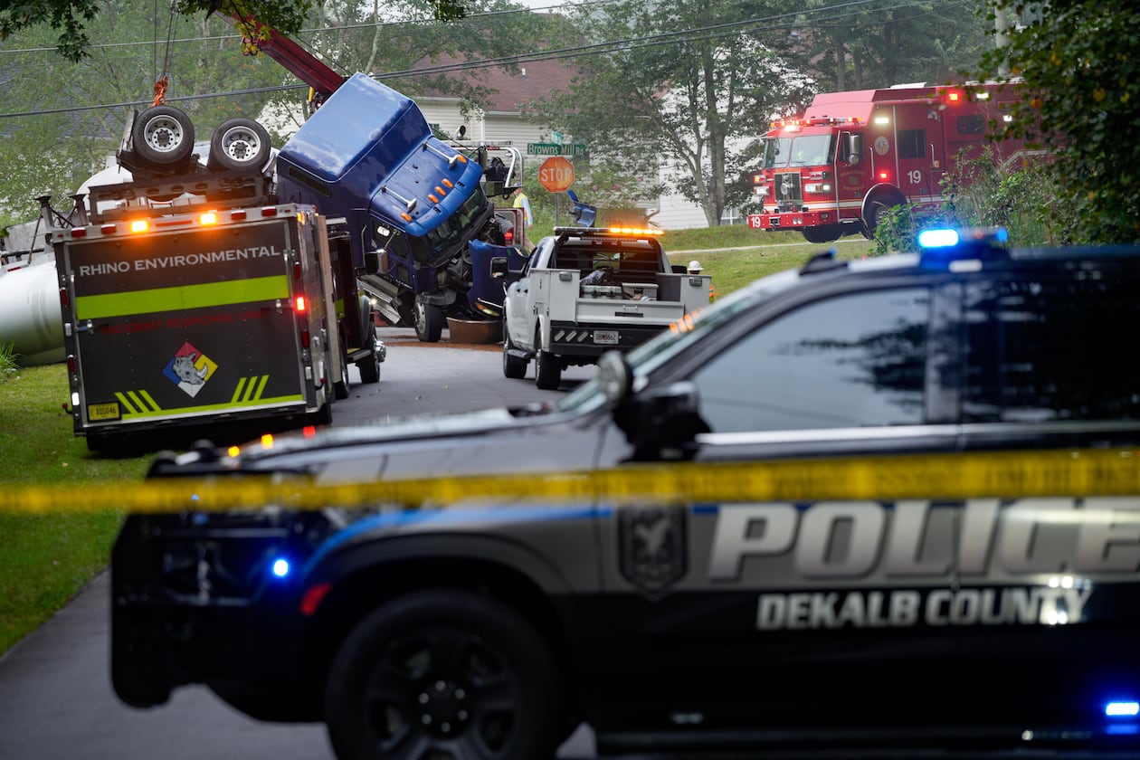 Parts of Browns Mill Road near White Circle were shut down in both directions on Friday, Aug. 28, 2026, as authorities addressed the overturned tanker truck. (Ben Hendren for the AJC)
