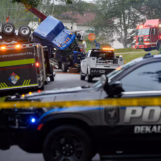 Parts of Browns Mill Road near White Circle were shut down in both directions on Friday, Aug. 28, 2026, as authorities addressed the overturned tanker truck. (Ben Hendren for the AJC)