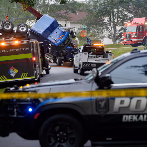 Parts of Browns Mill Road near White Circle are shut down in both directions on Friday, Aug. 28, 2026, as authorities address the overturned tanker truck. (Ben Hendren for the AJC)