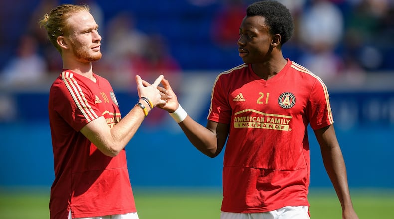 Homegrown Players Andrew Carleton (left) and George Bello (right) give a handshake before an away match against the New York Red Bulls on September 30, 2018. (Credit: Atlanta United)