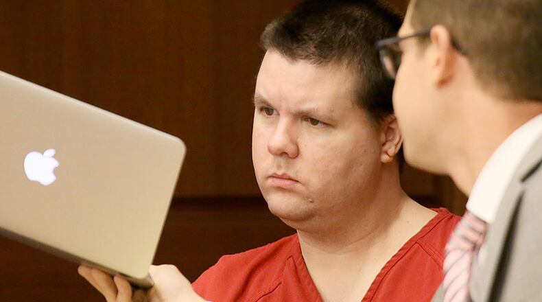 Justin Ross Harri examines information on a laptop with one of his defense attorneys during a hearing on Sept. 15, 2015. (Kelly J. Huff/Marietta Daily Journal via AP, Pool)