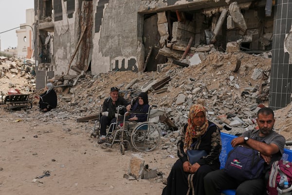 Kidney patients sit amid the destruction caused by the Israeli army at Shifa Hospital compound in Gaza City on Tuesday, July 1, 2025, as they wait to leave after the facility suspended its dialysis unit services due to fuel shortages needed to power its generators. (AP Photo/Jehad Alshrafi)