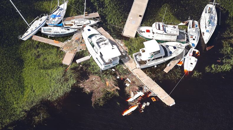 Boats and sections of dock are scattered in the marsh, some sitting on the bottom, after Hurricane Irma in 2017 in St. Marys. Previous docks were damaged by 2016's Hurricane Matthew and 2017's Hurricane Irma, limiting the number of vessels that could tie up. Public docking is now allowed on the island's Plum Orchard, Dungeness and Sea Camp docks. (Curtis Compton/ccompton@ajc.com)